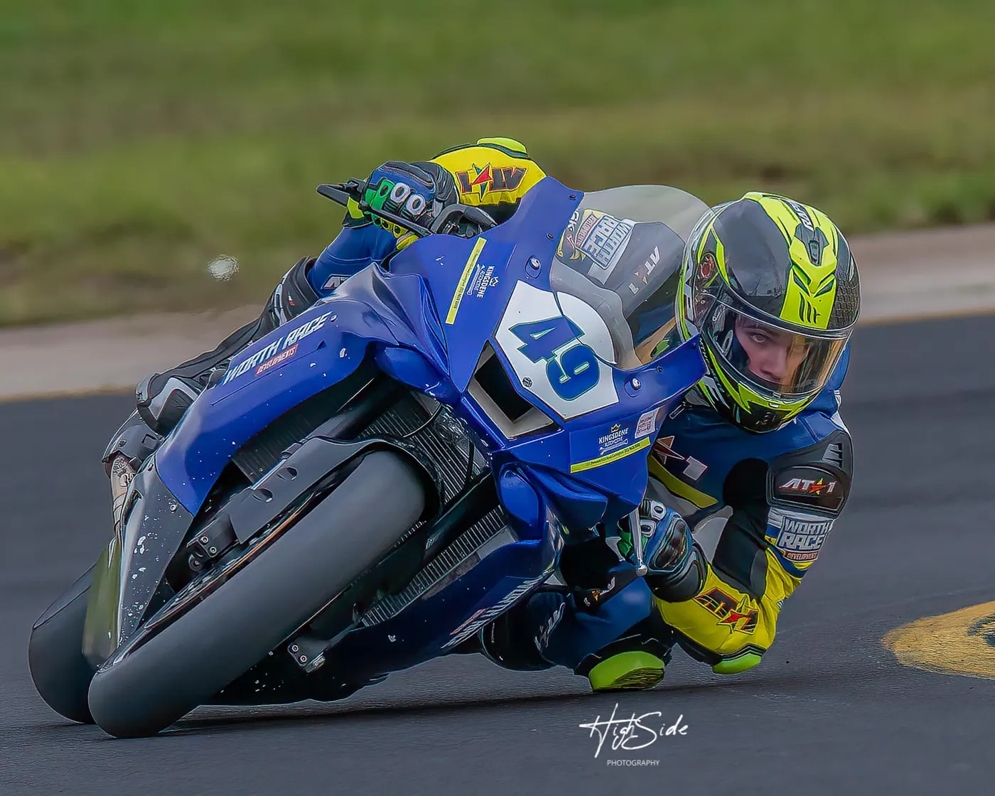 AT1 rider wheelie celebration at the track